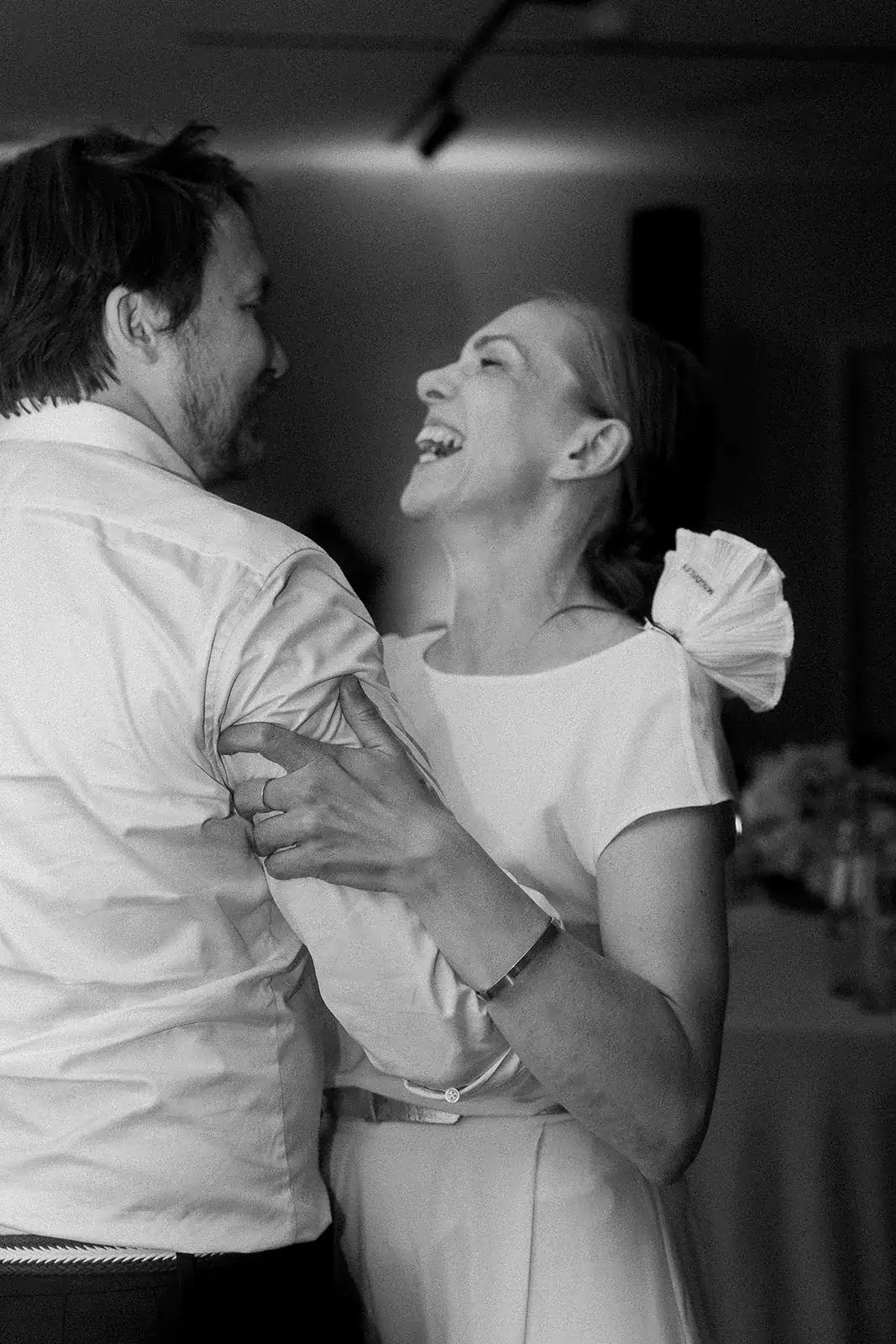 Black-and-white portrait of the wedding couple sharing an intimate moment