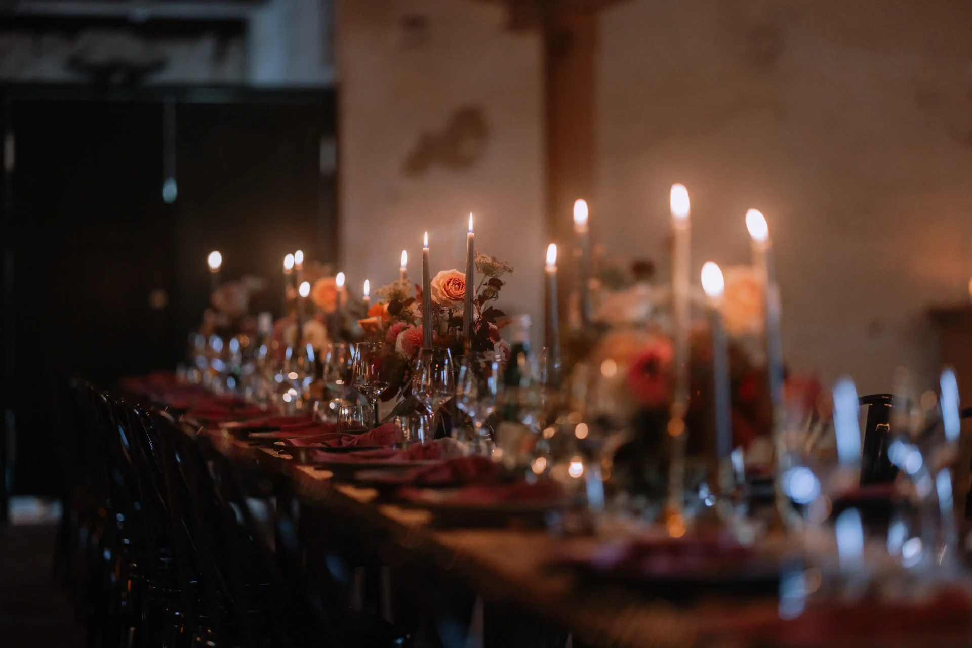 Wedding table in a barn with warm candlelight