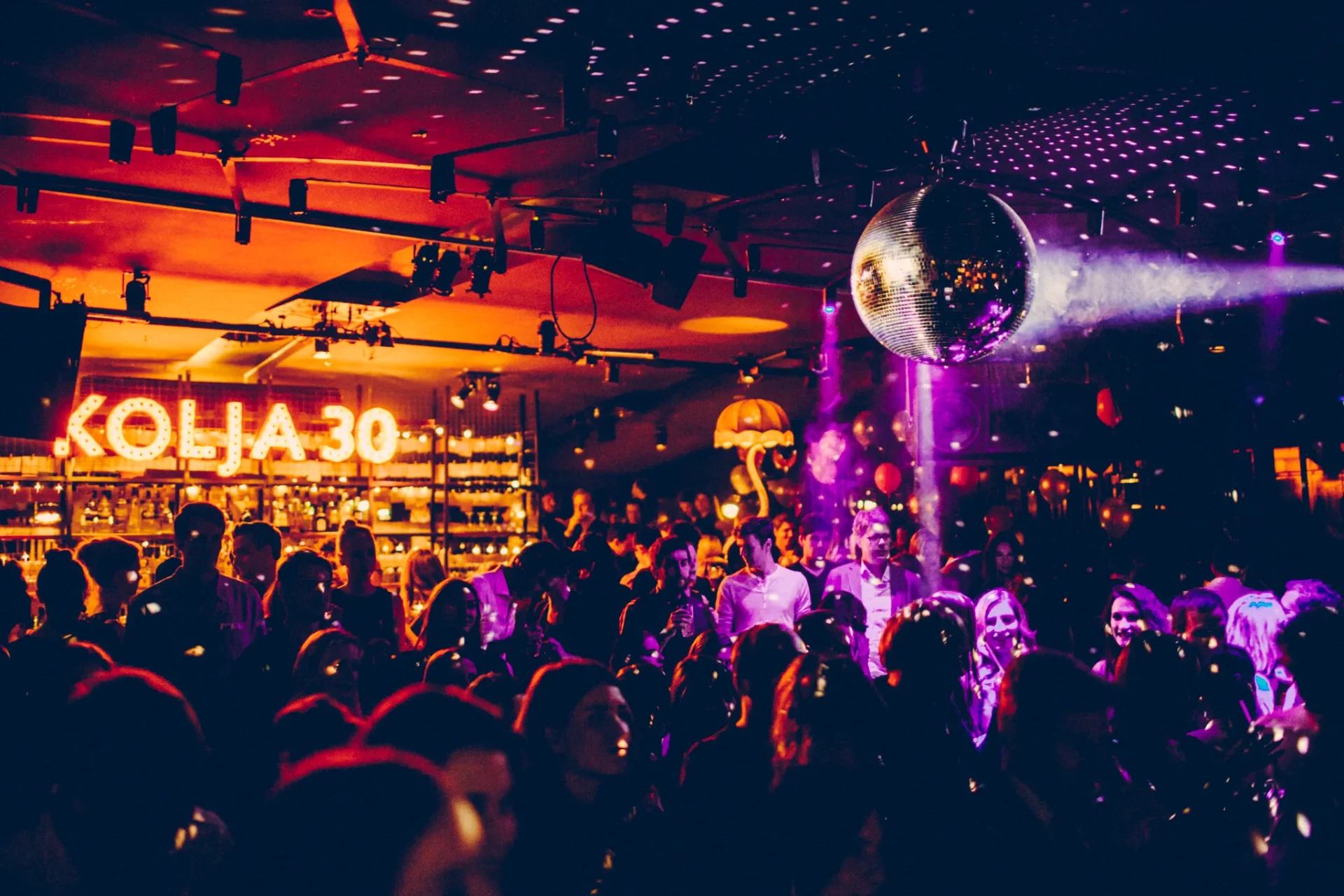 Birthday party with dancing guests and colourful lights