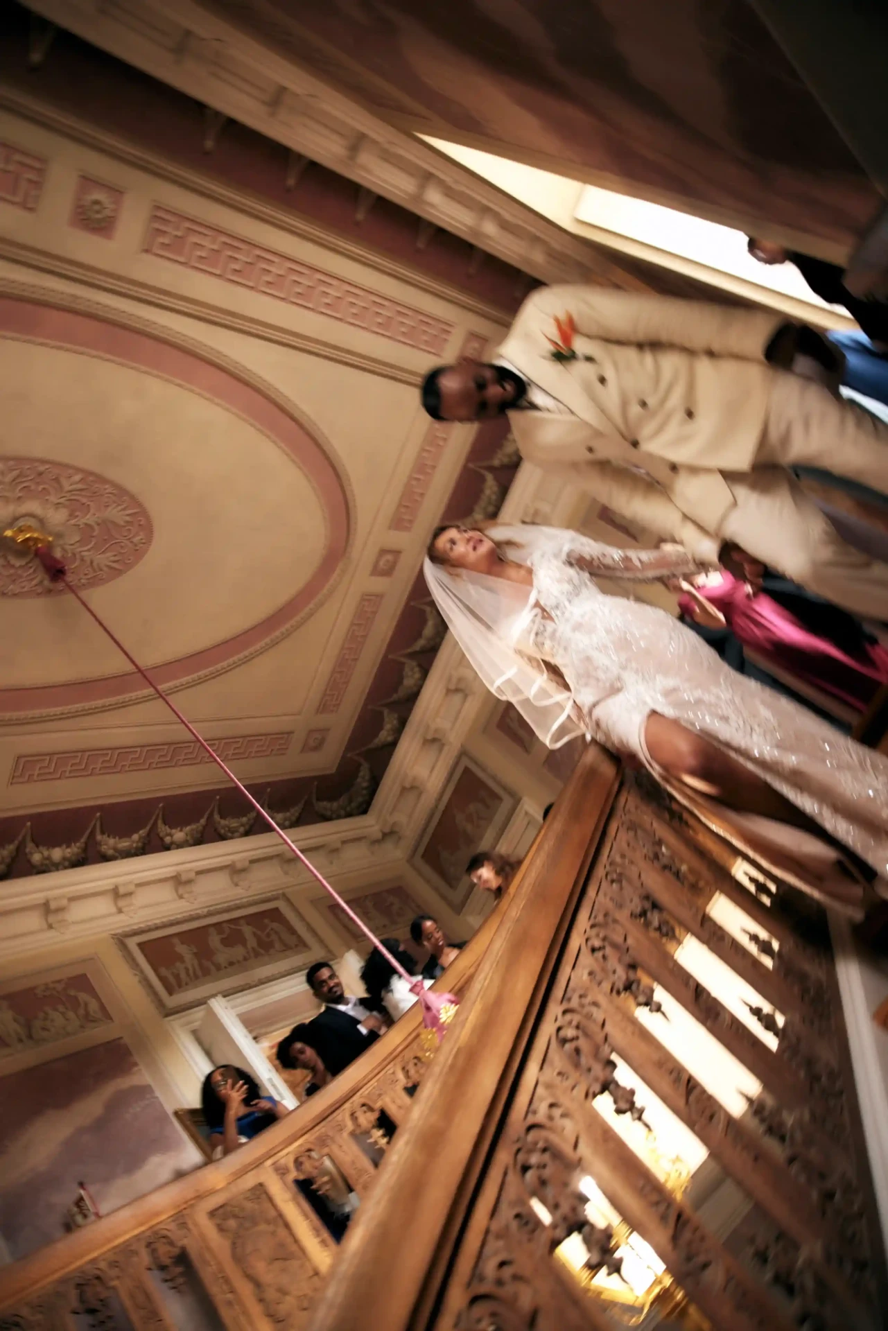 Overhead view of a historic hall with a wedding table and guests