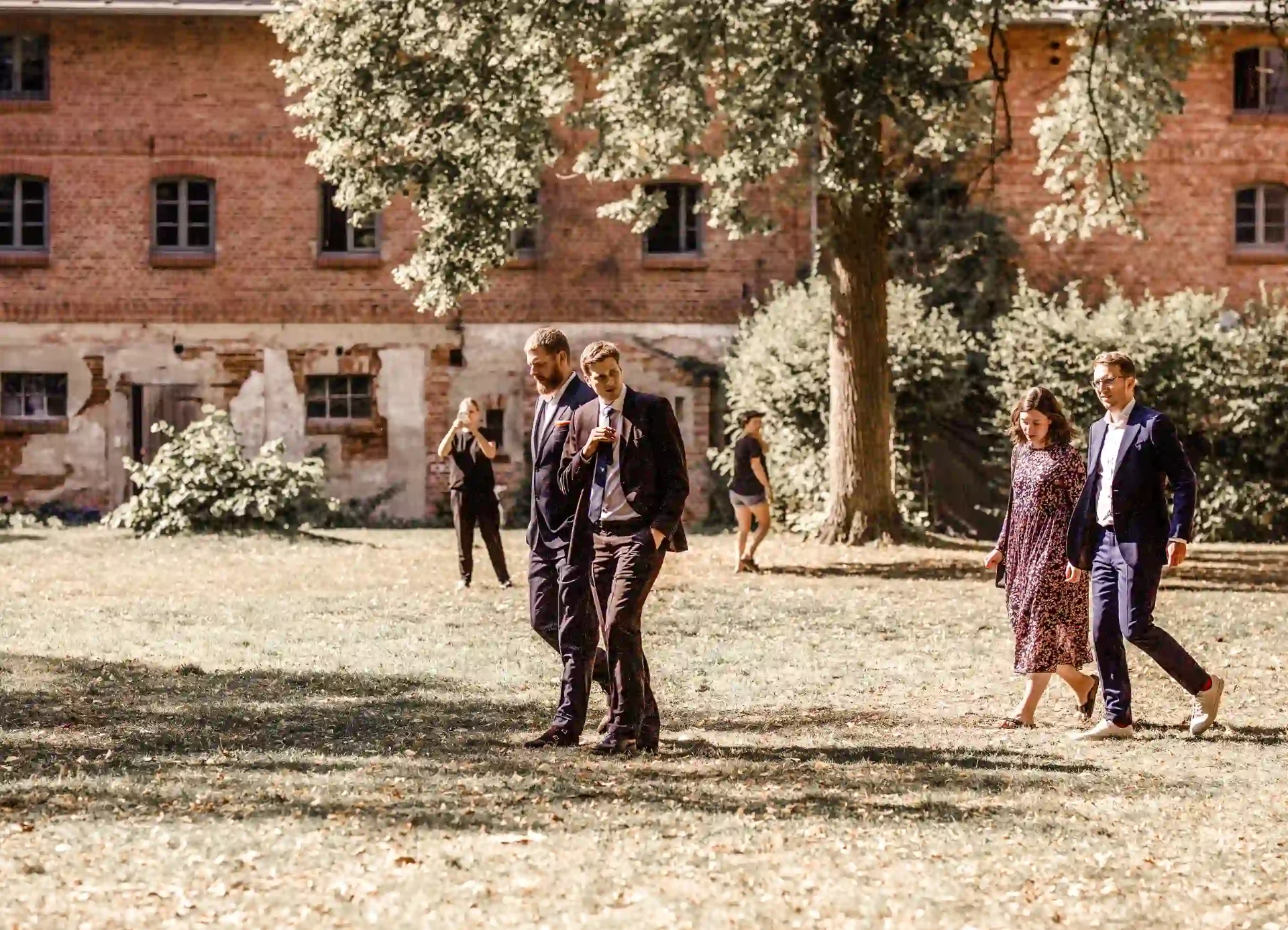 Wedding guests walking across the castle courtyard