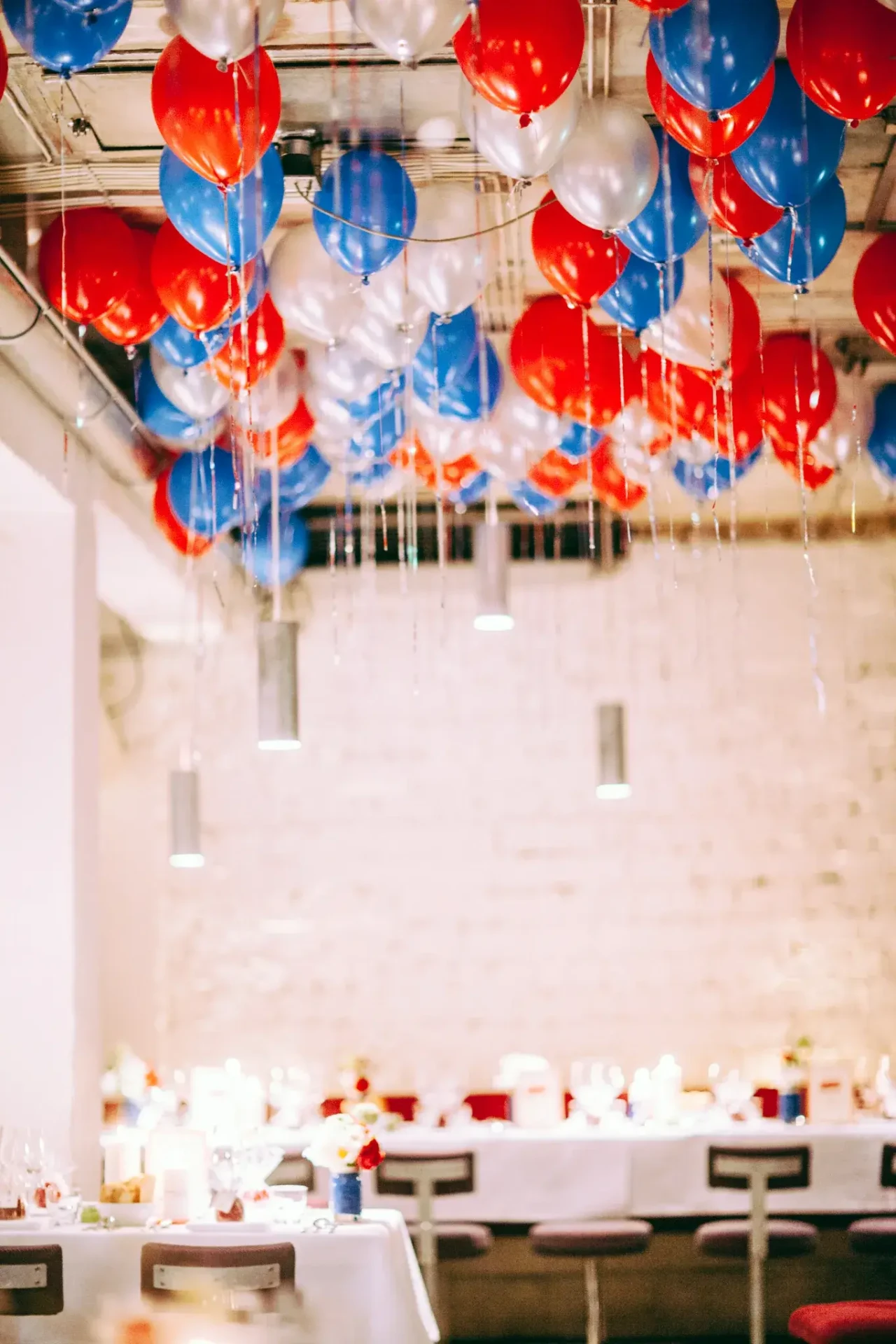 Festively set table with colourful balloons