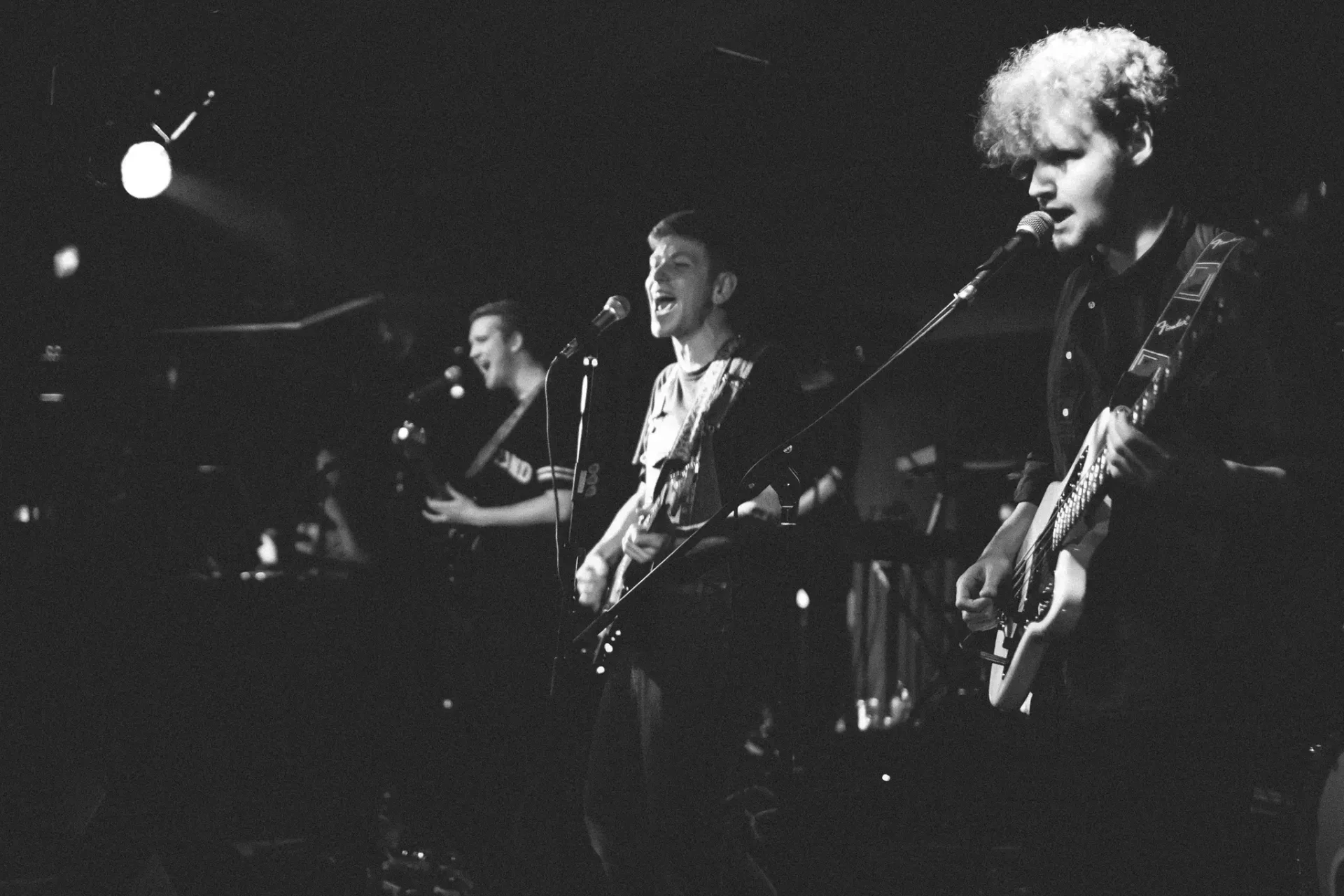 Two musicians performing in black and white