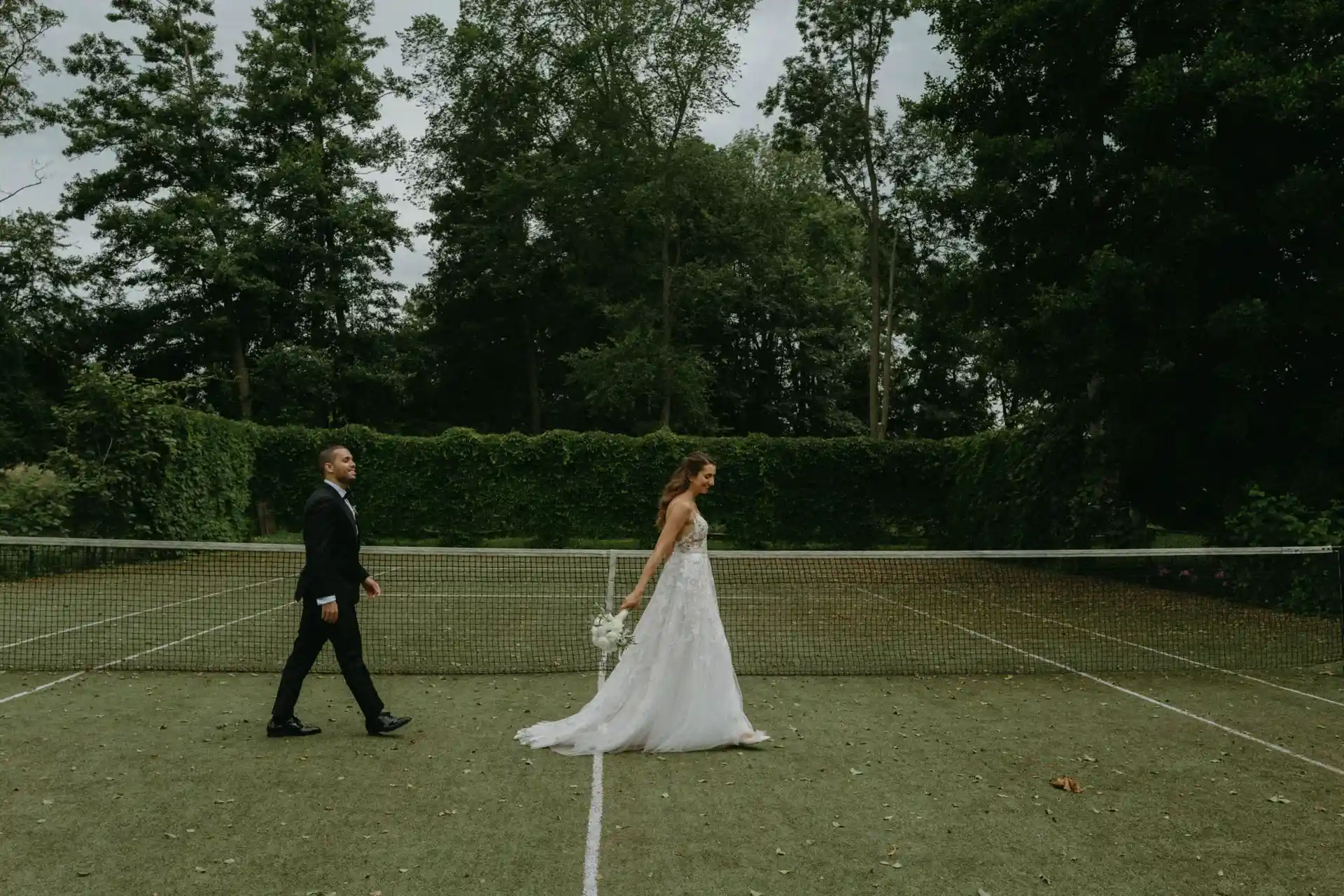 Wedding guests in blue suits celebrating outdoors
