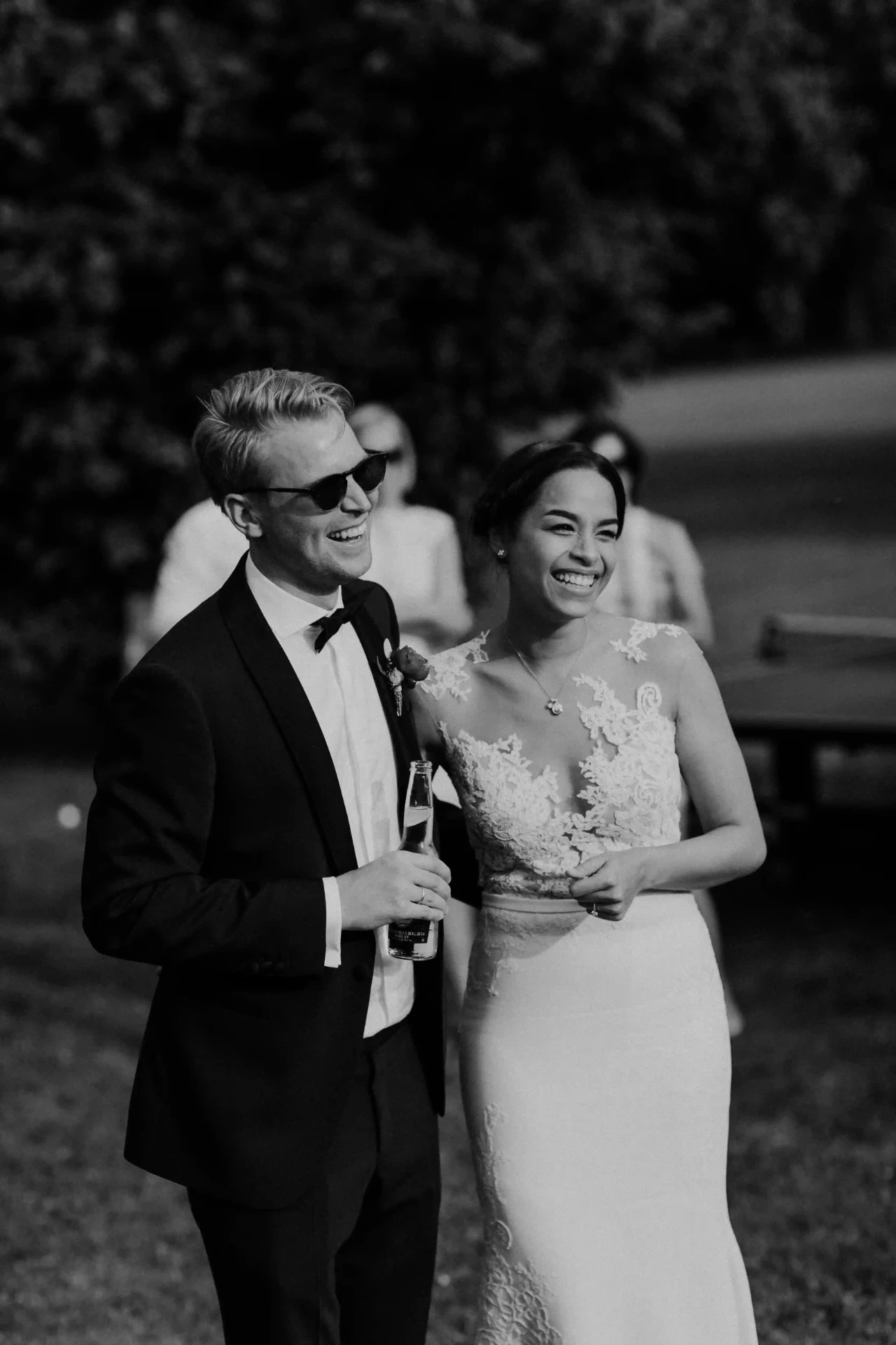 Bride and groom walking together in black and white