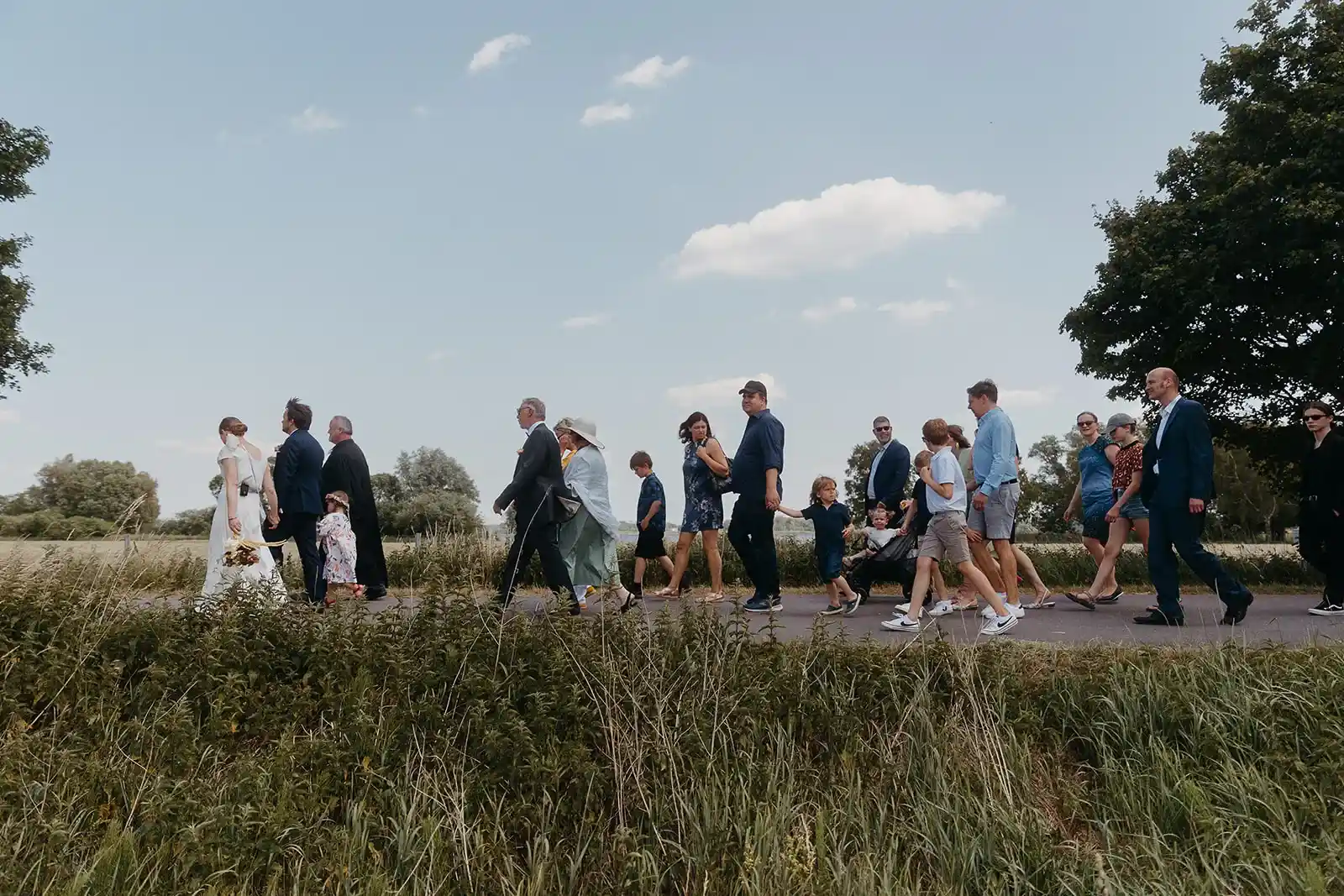 Wedding guests gathered on a lawn before the ceremony