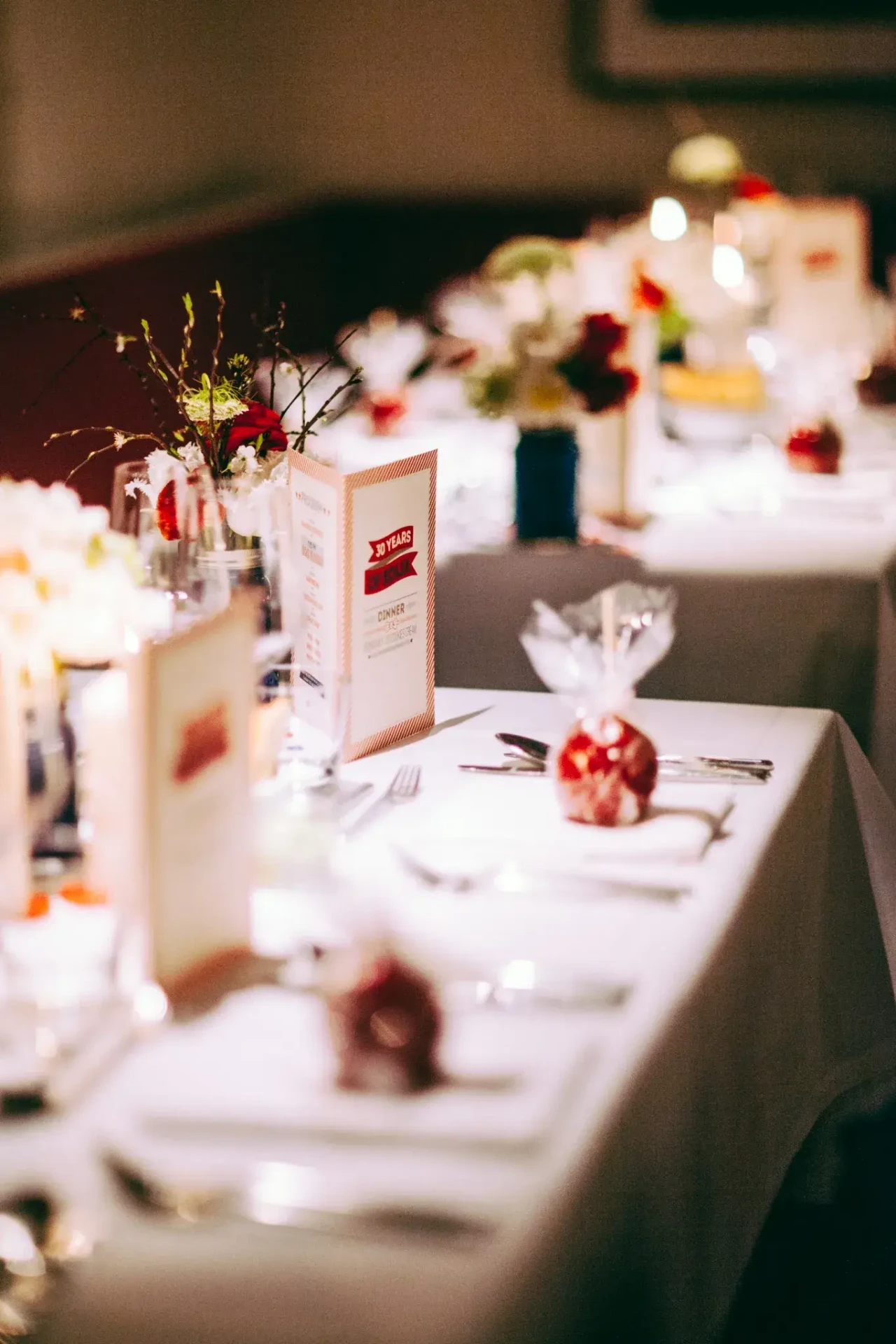 Long table with white linen and floral decorations